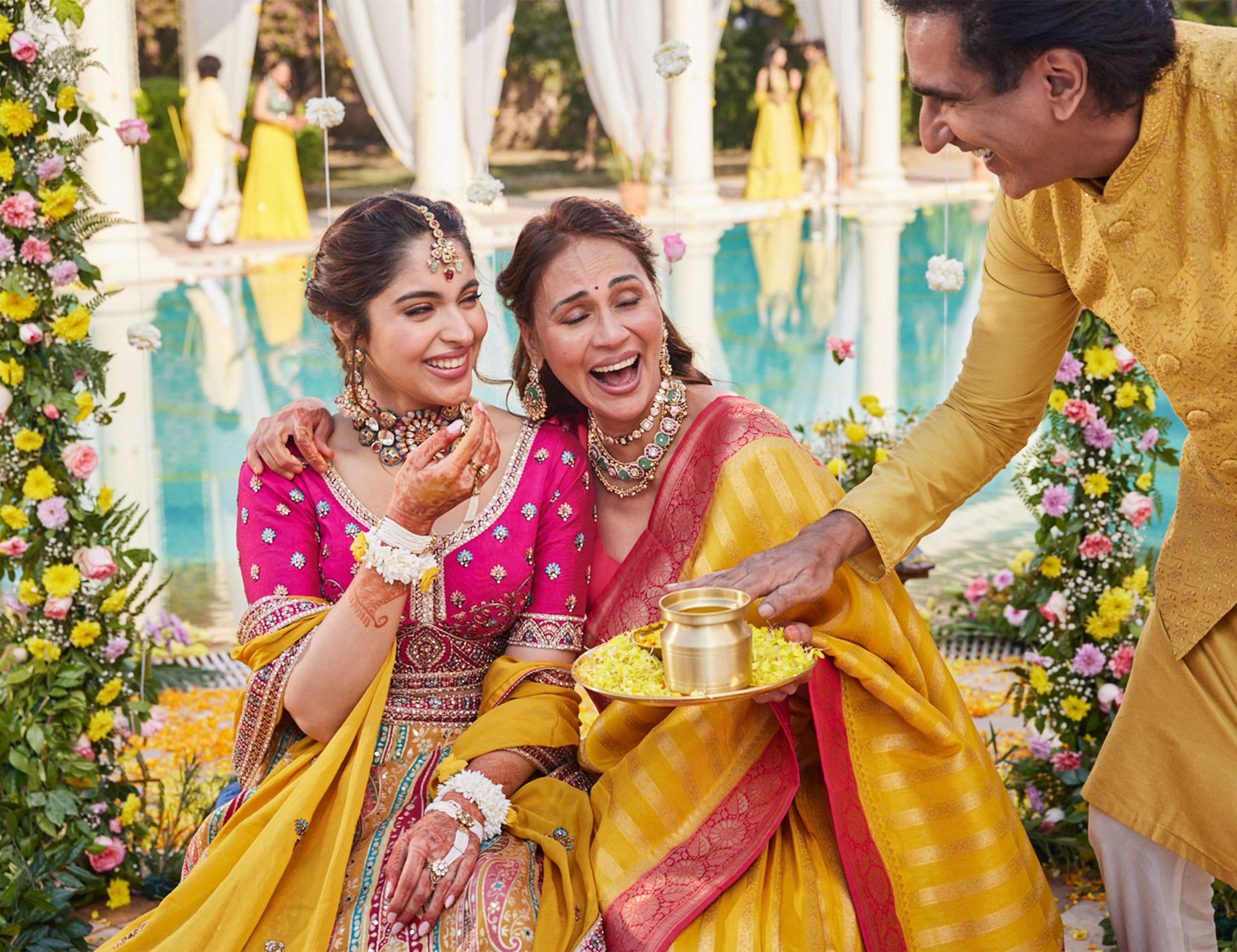 bride and her grandmother wearing a beige net saree with stone work